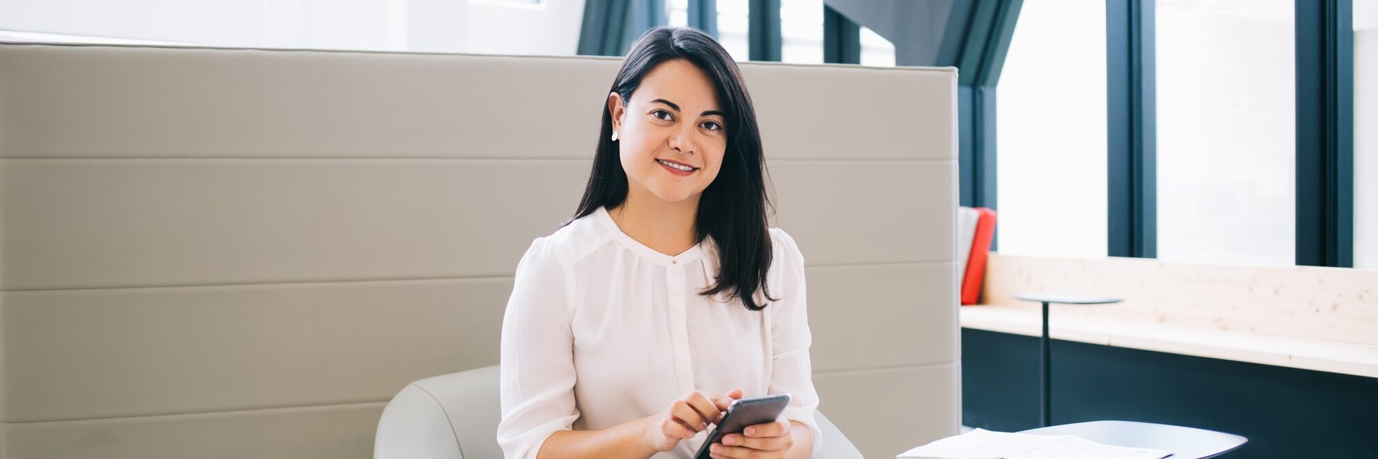 smiling sucessful businesswoman using smartphone for chatting and online communication